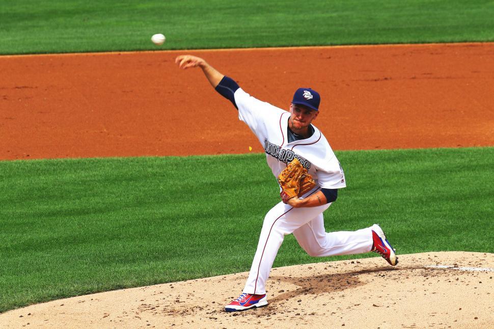 A baseball player pitching a ball