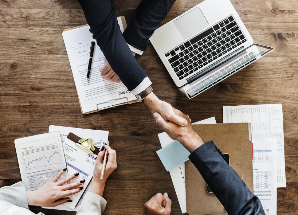 Two businessmen shaking hands over a deal